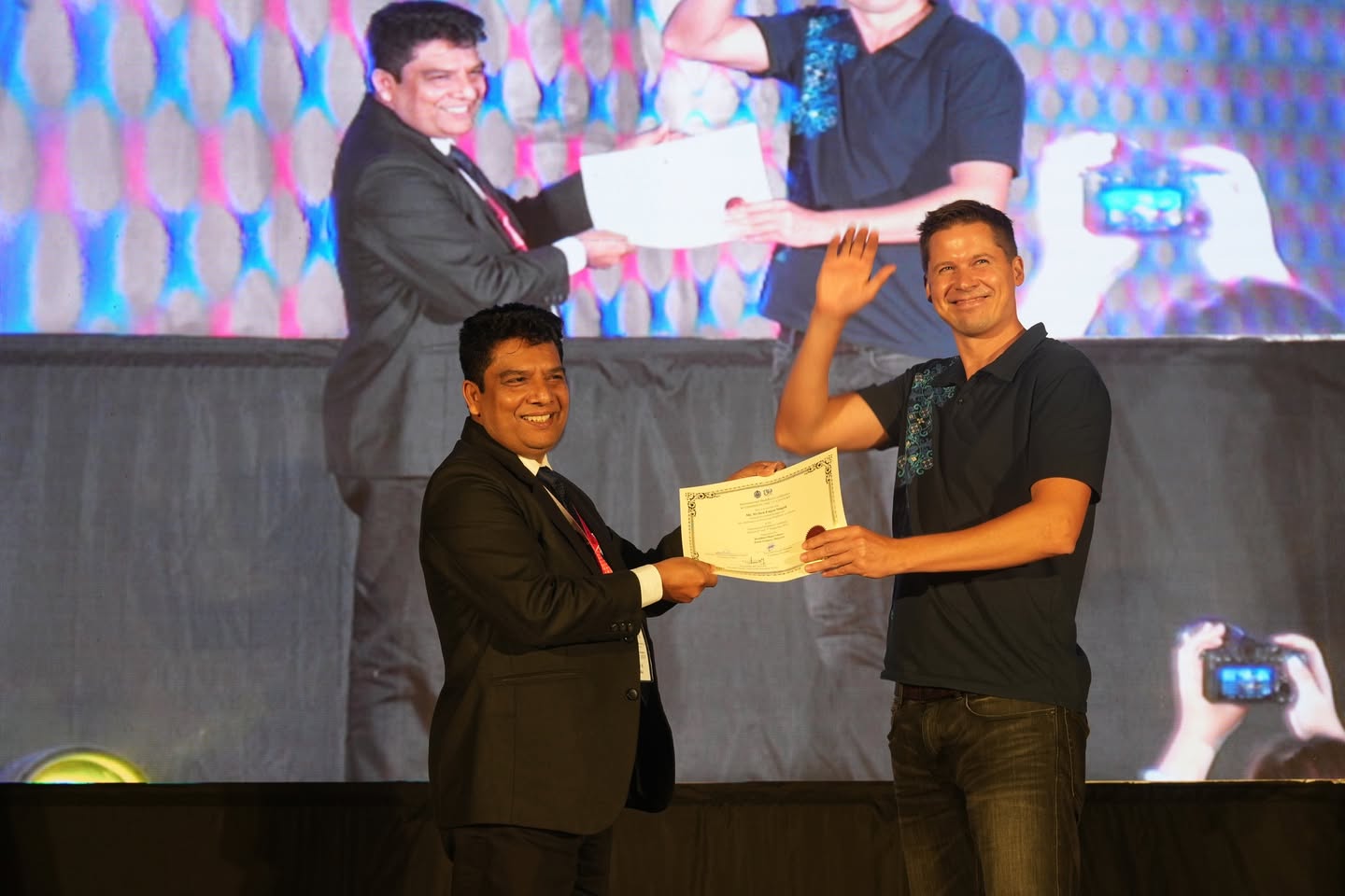 A Ukrainian representative receiving a certificate at the conference