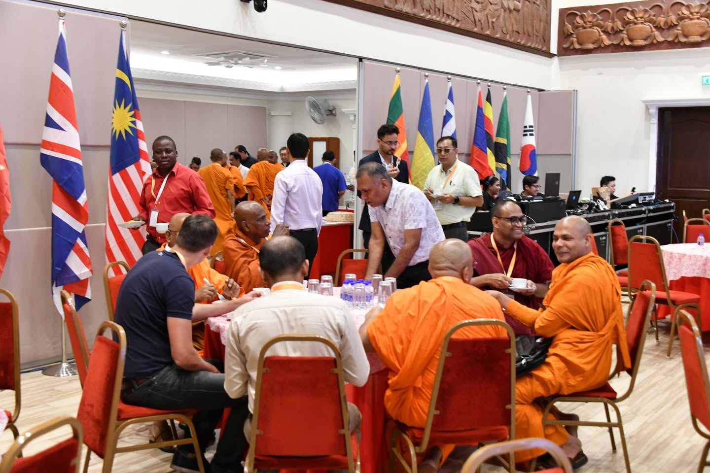 Monks and conference participants speaking during a break